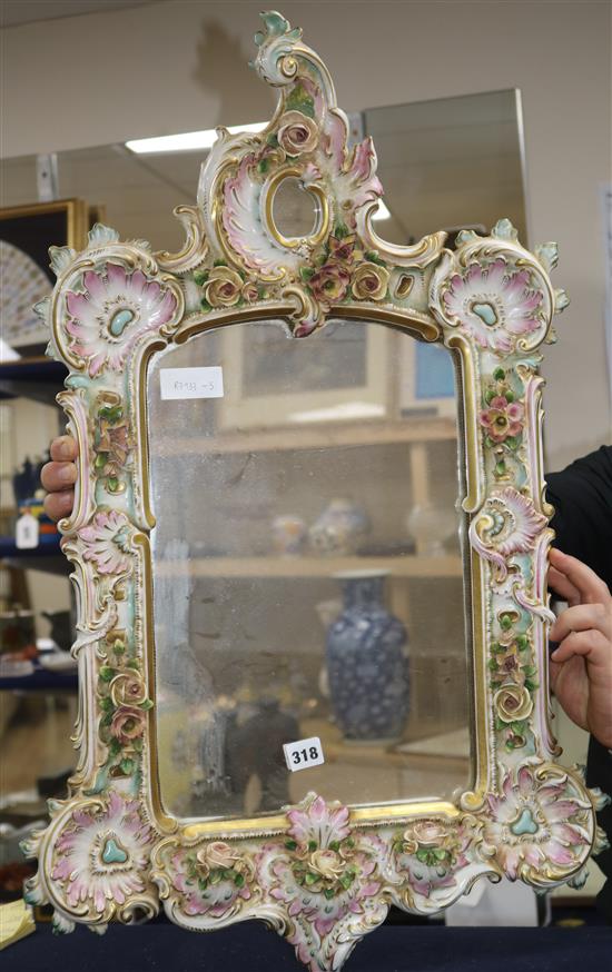 A porcelain framed mirror